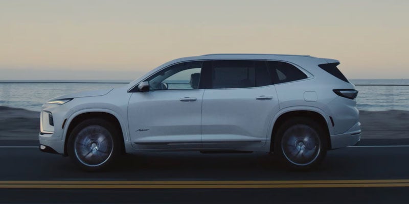 White SUV driving side view