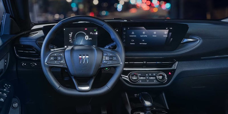 Modern SUV interior showing steering wheel and digital dashboard.